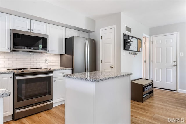 1905 King Arthur Ct, Maryland Heights Township, MO 63146 - kitchen with stainless steel appliances, white cabinetry, light wood-type flooring, and light stone counters