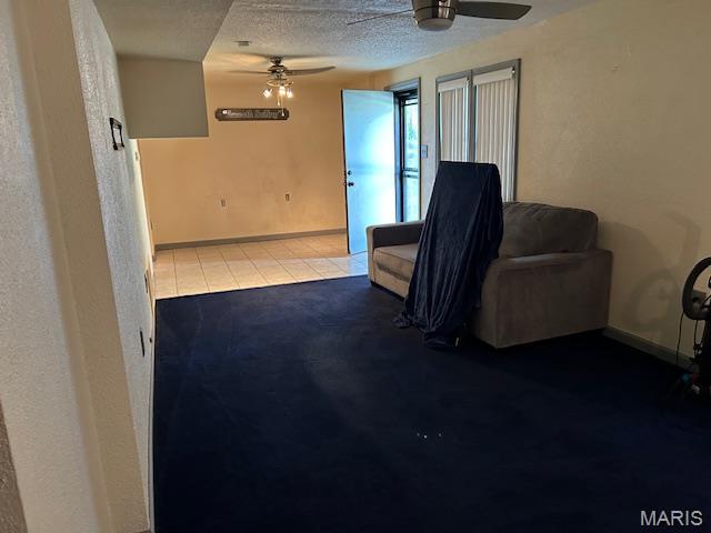1515 N Water St, Cape Girardeau, MO 63701 - living area featuring ceiling fan, a textured ceiling, and tile patterned floors