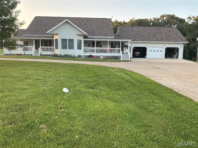 11996 County Road 3290, Rolla, MO 65401 - view of front of property with covered porch, driveway, a garage, and a front yard