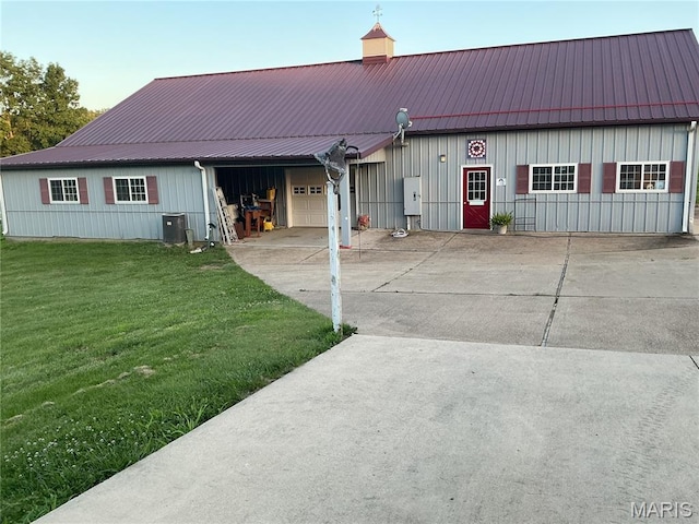 11996 County Road 3290, Rolla, MO 65401 - view of front facade with driveway, an attached garage, a front lawn, a metal roof, and board and batten siding