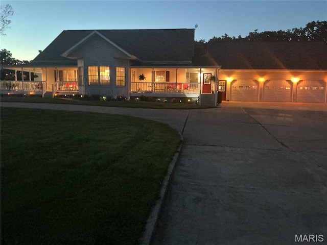 11996 County Road 3290, Rolla, MO 65401 - view of front of home featuring driveway, covered porch, a garage, and a front lawn