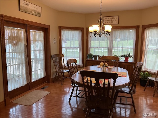 11996 County Road 3290, Rolla, MO 65401 - dining area with hardwood / wood-style flooring and a chandelier