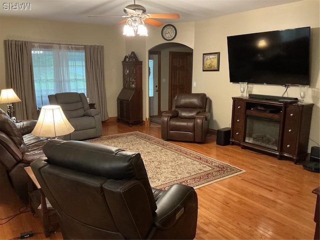 11996 County Road 3290, Rolla, MO 65401 - living room with ceiling fan, arched walkways, and wood finished floors