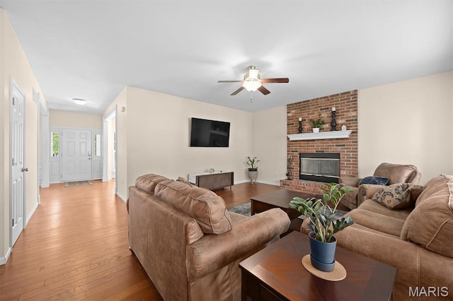 6817 Dunhill Dr, Fairview Heights, IL 62208 - living area featuring a ceiling fan, light wood-style floors, and a brick fireplace