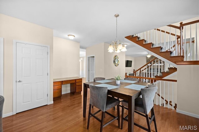 6817 Dunhill Dr, Fairview Heights, IL 62208 - dining area with stairway, wood finished floors, a chandelier, and built in study area
