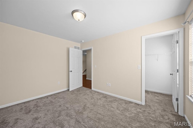 6817 Dunhill Dr, Fairview Heights, IL 62208 - unfurnished bedroom featuring carpet floors, a walk in closet, and a closet
