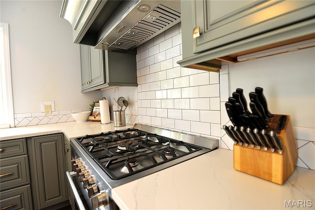 512 S 5th St, De Soto, MO 63020 - kitchen featuring stainless steel stove, ventilation hood, and backsplash