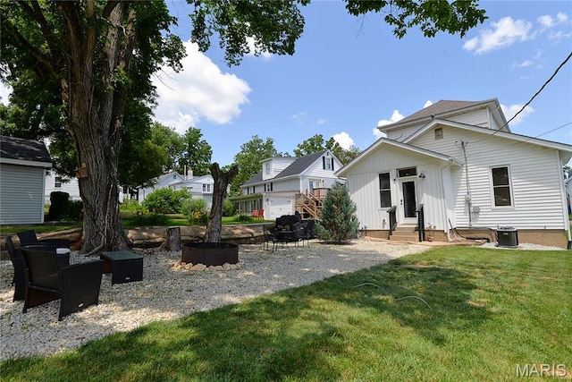 512 S 5th St, De Soto, MO 63020 - view of grassy yard with entry steps and an outdoor fire pit