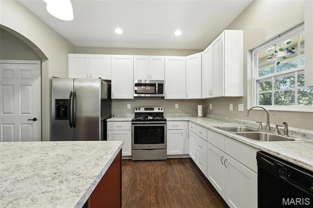 92 Lake Front Pt, Perryville, MO 63775 - kitchen featuring appliances with stainless steel finishes, dark wood finished floors, white cabinetry, recessed lighting, and arched walkways