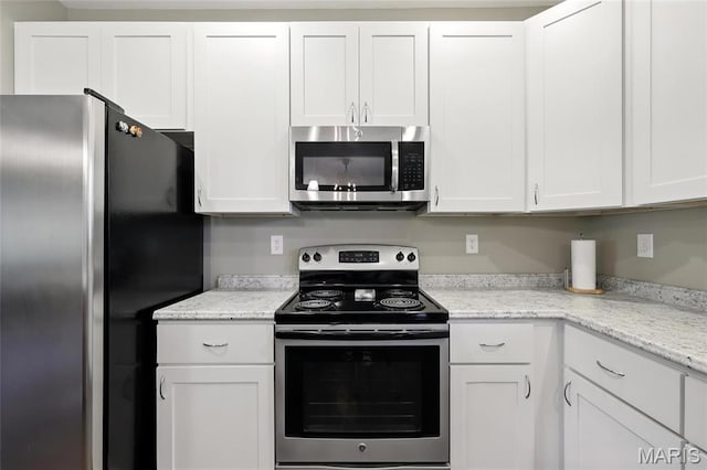 92 Lake Front Pt, Perryville, MO 63775 - kitchen with appliances with stainless steel finishes, white cabinetry, and light stone counters