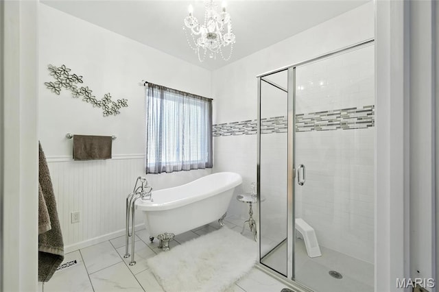92 Lake Front Pt, Perryville, MO 63775 - bathroom featuring a soaking tub, a shower stall, a wainscoted wall, a chandelier, and marble look tile flooring