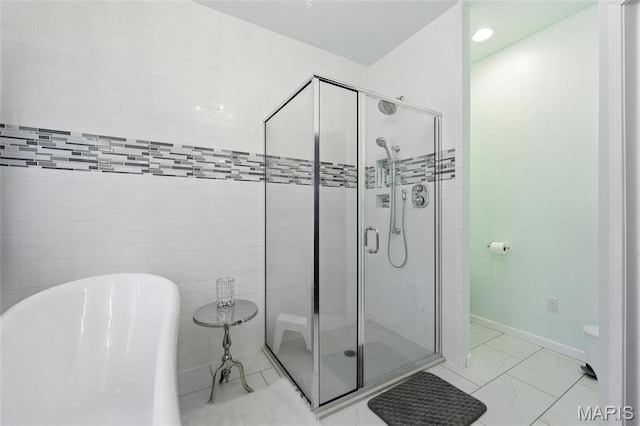 92 Lake Front Pt, Perryville, MO 63775 - bathroom with a freestanding tub, a stall shower, and marble finish flooring