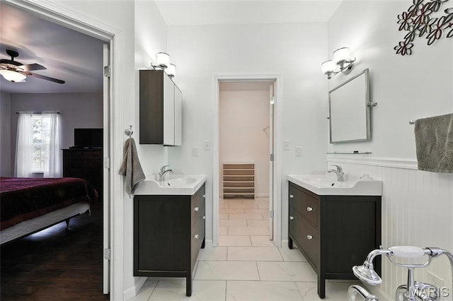 92 Lake Front Pt, Perryville, MO 63775 - bathroom with two vanities, a ceiling fan, ensuite bath, and wainscoting