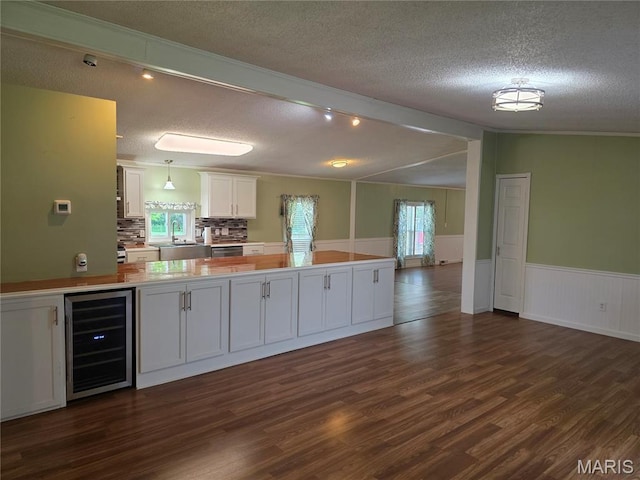 402 Il Route 143, Pocahontas, IL 62275 - kitchen with beverage cooler, a textured ceiling, white cabinetry, dark wood-type flooring, and open floor plan