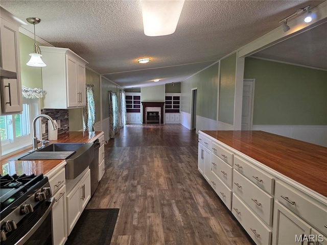 402 Il Route 143, Pocahontas, IL 62275 - kitchen featuring a fireplace, open floor plan, a textured ceiling, white cabinetry, and dark wood-style flooring