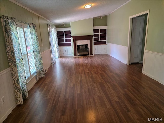 402 Il Route 143, Pocahontas, IL 62275 - unfurnished living room featuring ornamental molding, dark wood finished floors, a fireplace with flush hearth, a textured ceiling, and a wainscoted wall