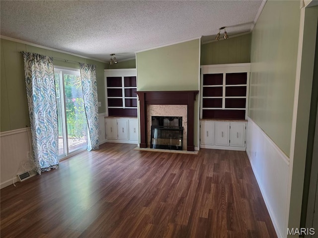 402 Il Route 143, Pocahontas, IL 62275 - unfurnished living room with ornamental molding, a textured ceiling, a tiled fireplace, a decorative wall, and wood finished floors