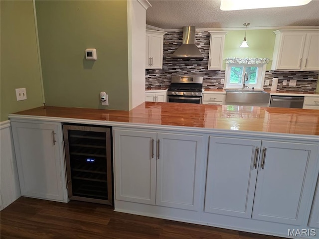 402 Il Route 143, Pocahontas, IL 62275 - kitchen featuring wine cooler, stainless steel appliances, wall chimney range hood, tasteful backsplash, and white cabinets