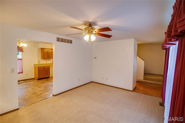 2933 Forest Dr, Alton, IL 62002 - spare room featuring light colored carpet, ceiling fan, and stairway