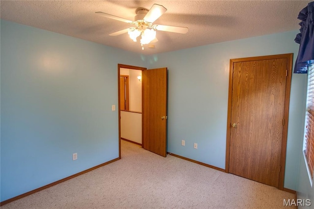 2933 Forest Dr, Alton, IL 62002 - unfurnished bedroom with carpet flooring, a textured ceiling, and ceiling fan