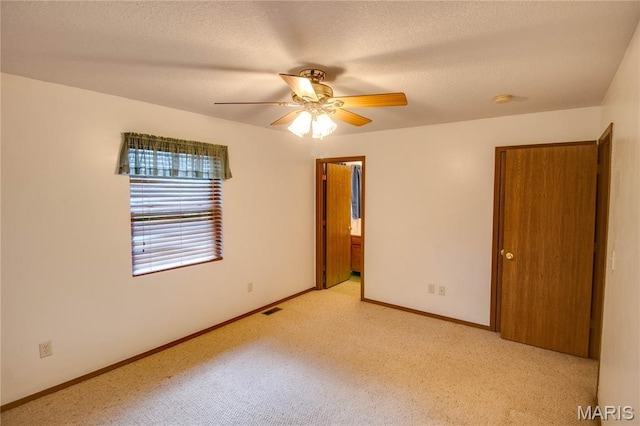 2933 Forest Dr, Alton, IL 62002 - unfurnished bedroom featuring light colored carpet, connected bathroom, and a ceiling fan