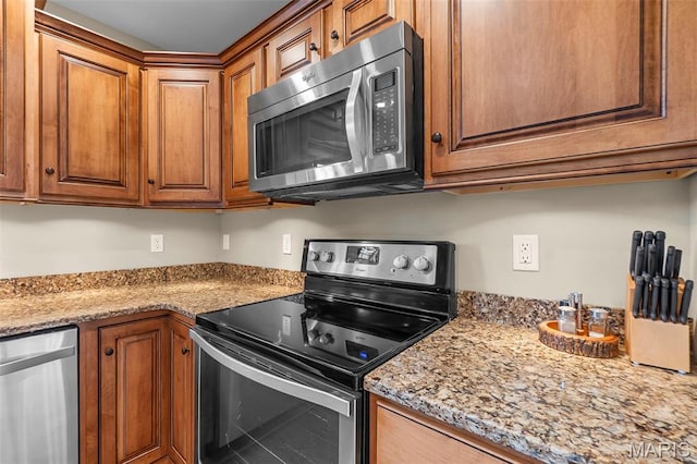 226 Indian Springs Dr, Jackson, MO 63755 - kitchen with stainless steel appliances, brown cabinets, light stone countertops, and tile patterned floors
