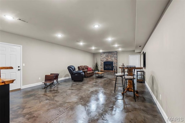 226 Indian Springs Dr, Jackson, MO 63755 - living area with finished concrete flooring, recessed lighting, and a fireplace