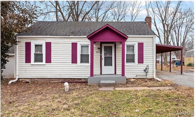 10109 Imperial Dr, Saint Louis, MO 63136 - view of front of house featuring asphalt driveway, a chimney, a carport, and a shingled roof