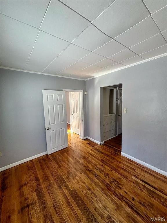 10109 Imperial Dr, Saint Louis, MO 63136 - empty room featuring wood finished floors and crown molding