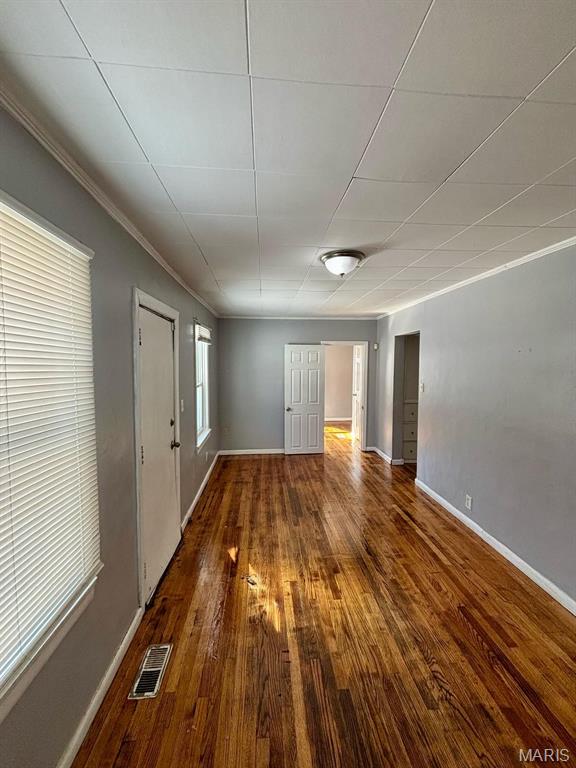 10109 Imperial Dr, Saint Louis, MO 63136 - spare room featuring hardwood / wood-style flooring and crown molding