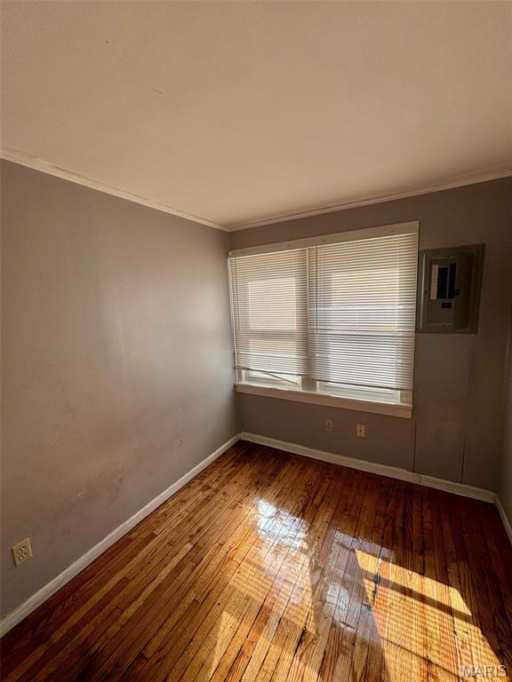 10109 Imperial Dr, Saint Louis, MO 63136 - empty room featuring ornamental molding, wood-type flooring, and electric panel