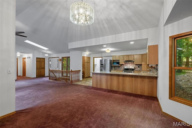 976 Aspenetter Dr, Innsbrook, MO 63390 - kitchen with lofted ceiling, open floor plan, carpet floors, a peninsula, and appliances with stainless steel finishes