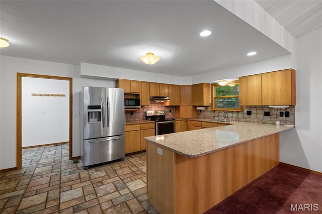 976 Aspenetter Dr, Innsbrook, MO 63390 - kitchen with a peninsula, appliances with stainless steel finishes, tasteful backsplash, brown cabinets, and recessed lighting