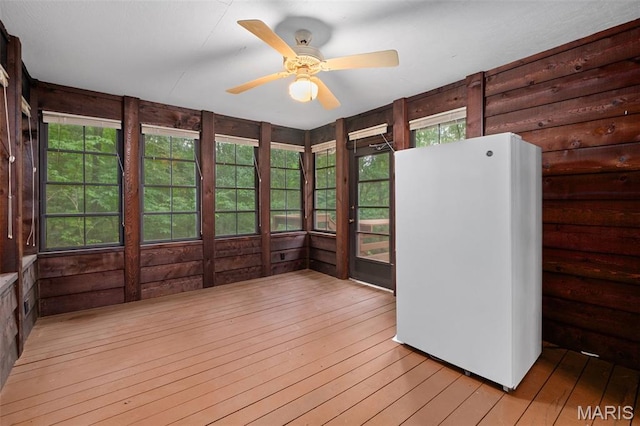 976 Aspenetter Dr, Innsbrook, MO 63390 - unfurnished sunroom featuring hardwood / wood-style flooring, a ceiling fan, and wood walls