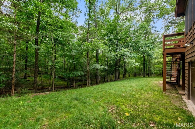 976 Aspenetter Dr, Innsbrook, MO 63390 - view of grassy yard featuring stairs, a wooden deck, and a view of trees