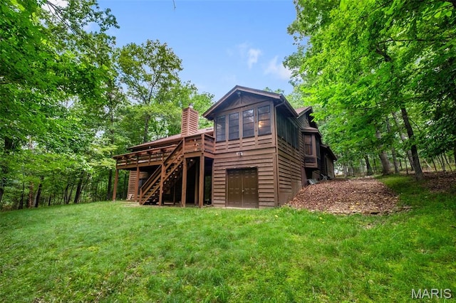 976 Aspenetter Dr, Innsbrook, MO 63390 - rear view of house with stairway, a deck, a lawn, and a chimney