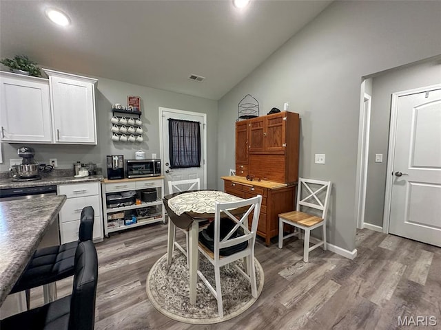 326 Apple Park Way, Poplar Bluff, MO 63901 - kitchen featuring wood finished floors, white cabinets, stainless steel microwave, recessed lighting, and high vaulted ceiling