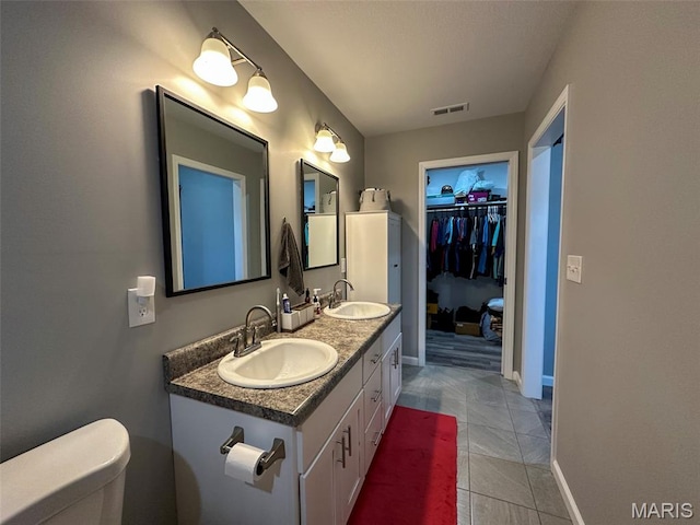 326 Apple Park Way, Poplar Bluff, MO 63901 - bathroom with double vanity, a spacious closet, and tile patterned floors