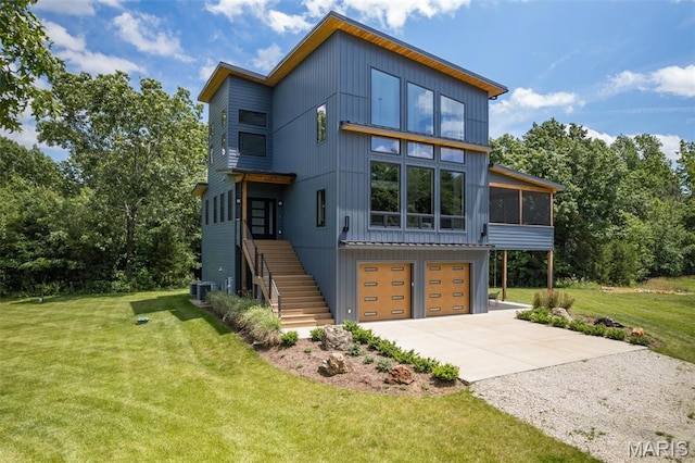 25360 N State Highway 21, De Soto, MO 63020 - contemporary home with driveway, stairway, an attached garage, a front yard, and a sunroom