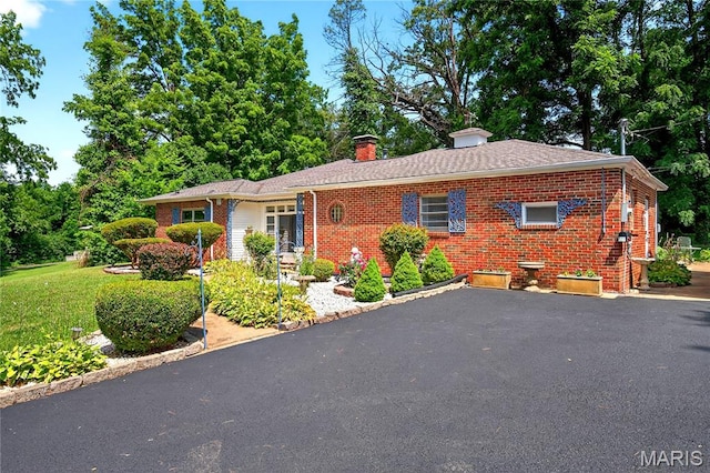 351 N 66th St, Belleville, IL 62223 - view of front of house featuring brick siding, a chimney, a front yard, and asphalt driveway