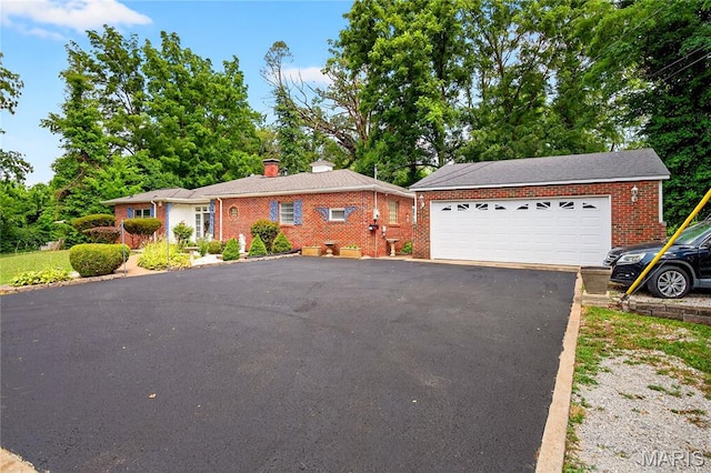 351 N 66th St, Belleville, IL 62223 - ranch-style home featuring brick siding, a chimney, and a garage