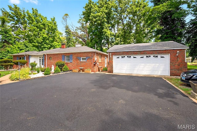 351 N 66th St, Belleville, IL 62223 - ranch-style home with brick siding, a chimney, and a detached garage