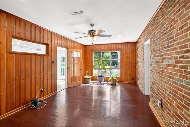 351 N 66th St, Belleville, IL 62223 - foyer entrance with brick wall, dark wood-style flooring, wood walls, a ceiling fan, and crown molding