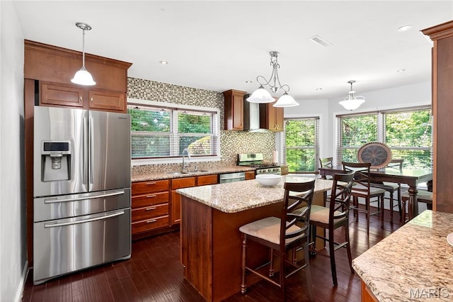 351 N 66th St, Belleville, IL 62223 - kitchen featuring stainless steel appliances, brown cabinetry, tasteful backsplash, dark wood-style flooring, and recessed lighting