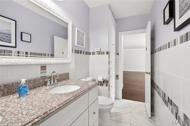 351 N 66th St, Belleville, IL 62223 - bathroom with tile walls, marble look tiles, and vanity