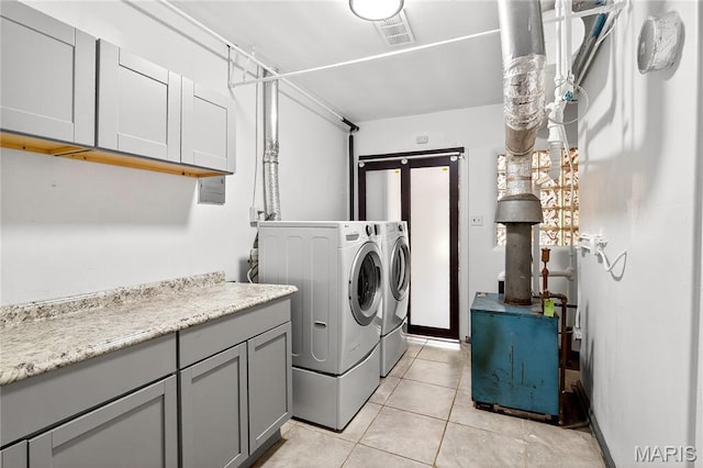 351 N 66th St, Belleville, IL 62223 - washroom featuring washing machine and dryer, cabinet space, and light tile patterned floors