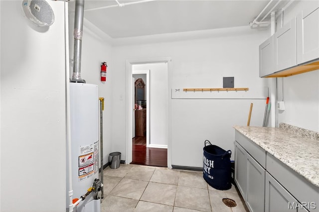 351 N 66th St, Belleville, IL 62223 - laundry area with water heater and light tile patterned floors