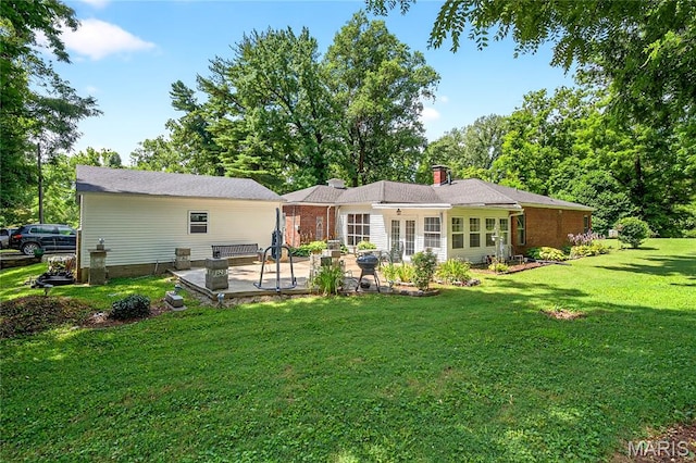 351 N 66th St, Belleville, IL 62223 - back of property with a patio, a lawn, french doors, and a chimney