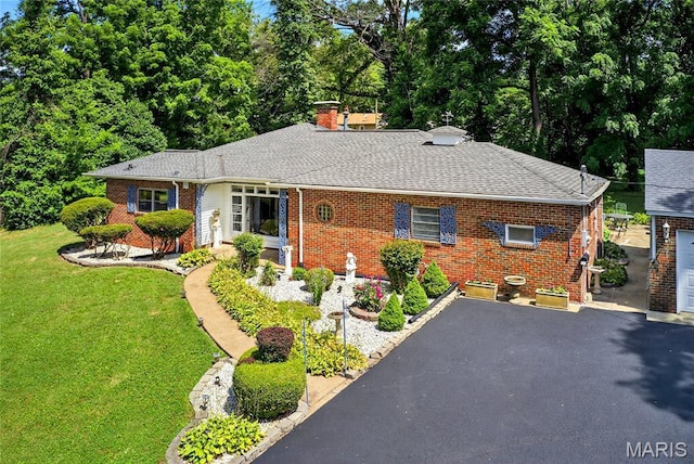 351 N 66th St, Belleville, IL 62223 - view of front of property with brick siding, a front lawn, a shingled roof, and a chimney