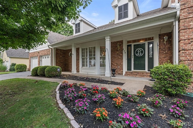649 Westledge Ct, Des Peres, MO 63131 - doorway to property featuring covered porch, brick siding, a garage, and driveway
